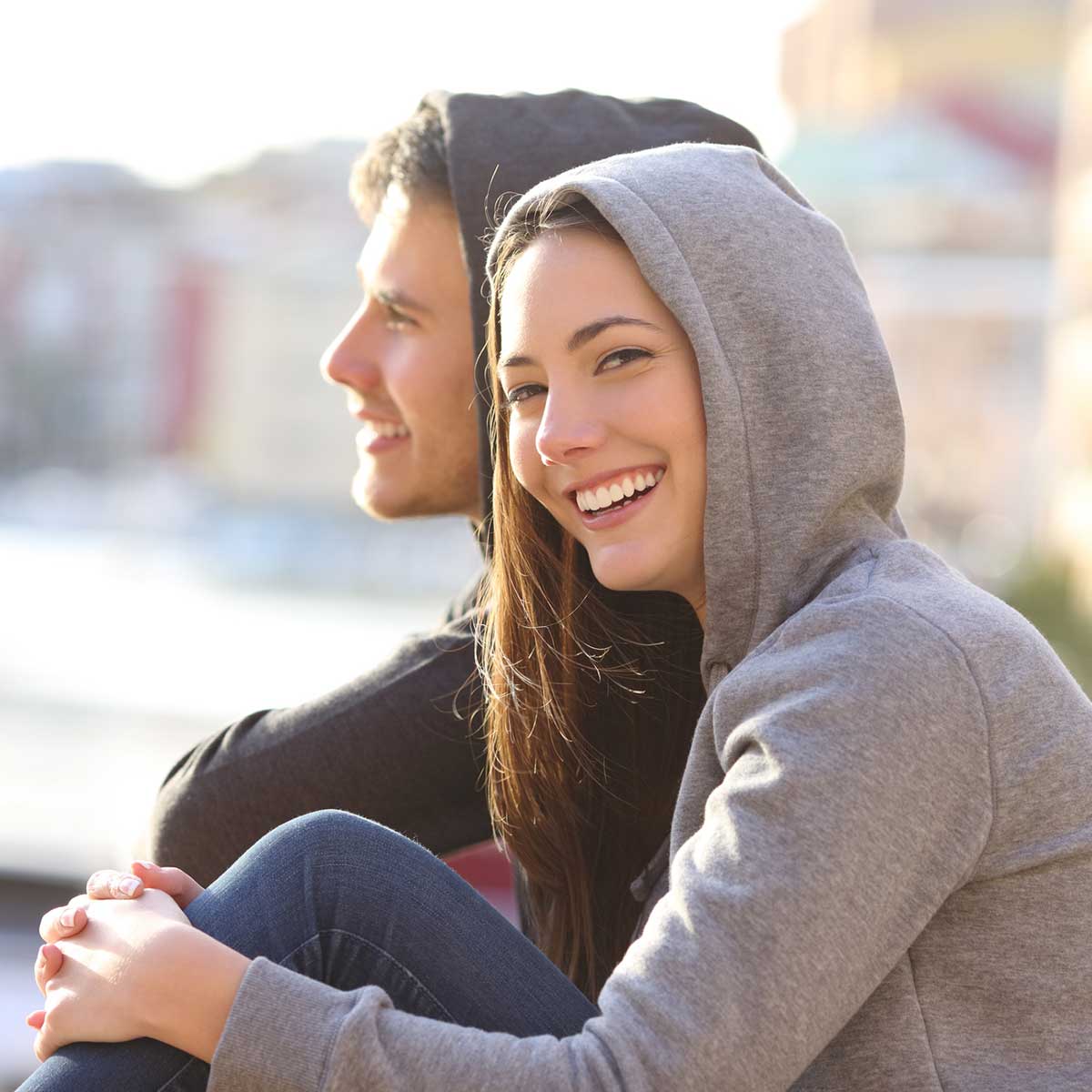 Young couple wearing Schel hoodies